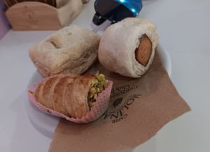 Pistachio filled pastry cone thing, sausage roll, spinach and cheese filled pastry at Pasticceria Vegana Biologica La Magnolia in Verona