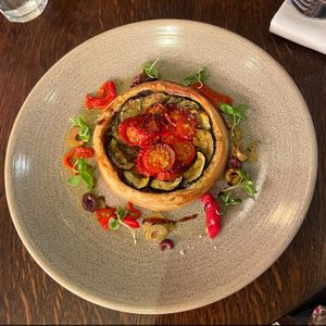 Tomato and Courgette tart with olives, peppers and balsamic glaze.  at Brasserie Blanc in Portsmouth