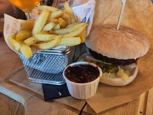Red beetroot burger with sweet pickles and spicy BBQ sauce and fries. Salad ordered without dressing. at Frietboetek in Middelkerke