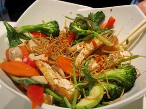 Vegetables stir-fried with mixed proteins and served on crispy noodles at Quan Bo De Cuisine Vegetarienne in Montreal