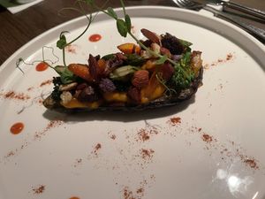 Aubergine filled with vegetables and nuts in the oven   at Oltre il Ristorante in Schilde