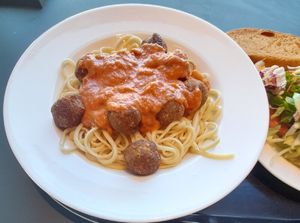 Bucatini with vegetable "meat" balls and tomato sauce, salad, bread at Ravintola Arvo in Espoo