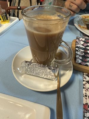 Vegan oat milk latte (dolce gusto) with a biscuit (like a bisscoff biscuit)   at Mac's Tearoom in Gran Canaria