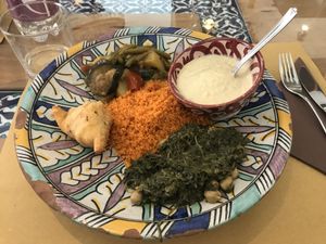 Tomatoes couscous, curry vegetables, vegan hummus, samosas, spinach at Orient Experience in Venice