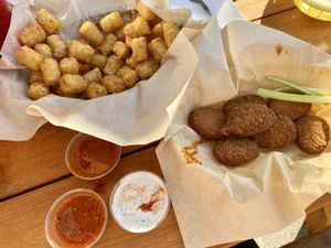 Tots, vegan ranch, cilantro lime wing sauce, and the nuggets (you toss in sauce yourself) at Fire on the Mountain in Portland
