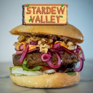 Prueba nuestra burger de proteína de guisante 100% vegana con lechuga, tomate, nuestra cebolla dulce encurtida casera, salsa de romesco y nueces  en pan mollete. at Afterlife eSports Gamer Bar in Barcelona