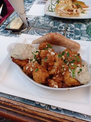 Vegan main course, grilled cauliflower with paprika sauce, artichokes hummus and pita bread at Kapitein Zeppos in Amsterdam