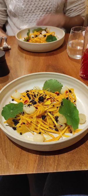 Pumpkin puree with pumpkin spaghetti, turnips and roasted olives. More flowers. at Auberge Des Aryelets in Aulon