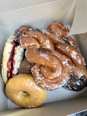 Raspberry turnover, cinnamon twists, glazed and a chocolate cream filled at the bottom.   at Ronald's Donuts in Las Vegas