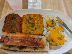 Vegan sunny side up eggs (yo egg), breakfast sausage, hash browns, cuban buttered toast and lavender lemonade. at A Lo Vegano Orlando in Orlando