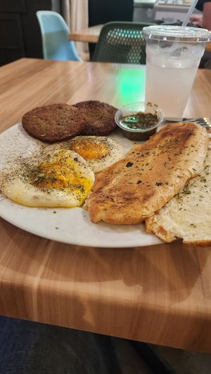 Over medium fried eggs, vegan sausage patties, chimichurri sauce, Cuban toast, lavender lemonade! at A Lo Vegano Orlando in Orlando