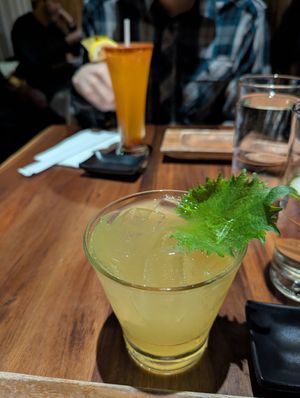 Shiso Shrub Mocktail (front, with ao shiso leaf), pineapple li hing soda (back, with paper straw and lemon). at Tane Vegan Izakaya in Palo Alto