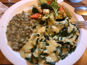 Tio plate: Mung beans w onions, sautéed broccoli, carrots, cauliflower, celery w tofu garlic onion sauce, collard greens and kale w shiitake la bocha and onion sauce   at Peace Natural Vegan Food in Berkeley