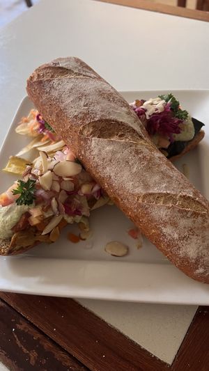 Sandwich with cashew cream cheese and grilled veggies + plantain chips.  at Pan & Paz in Leon