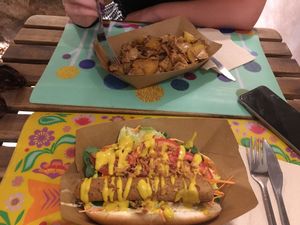 Hot dog and chicken with potatoes.  at El Cafe Blueproject in Barcelona