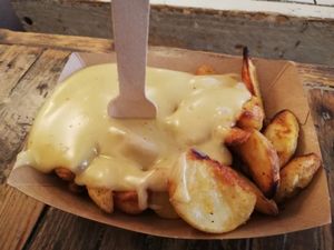 Melted cheese on fried potatoes at Hank Cuisine Végétale - Archives in Paris