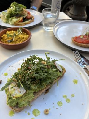 The avocado toast has SO much flavour, the other dishes pictured are the Spanish toast, a side of tofu scramble, and the chickpea omelette, which were all amazing as well!!  at Let It Bloom in Valencia