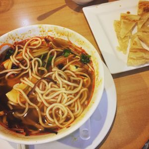 Noodles with sour and spicy soup & sesame pancake at Sunflower Thai Vegetarian Restaurant in Auckland