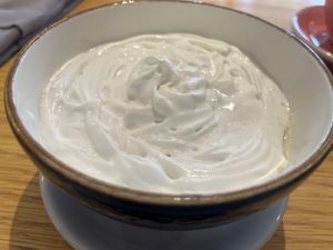 Porridge with coconut milk, cream and diced mango  at Big Apple Coffee Shop in Astana