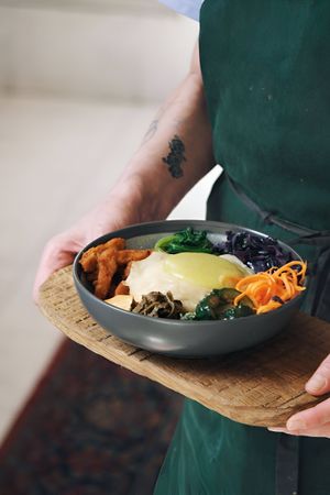 Bibimbap: non-egg, rice, morkovcha, kale, homemade kimchi, non-chicken, red cabbage, smashed cucumbers, lime at Kruzhok in Yerevan