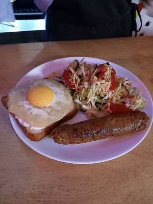 A fried egg with a smoky sausage and salad at Kruzhok in Yerevan