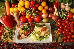 Crispy Tofu with Mango Salad is vibrant and refreshing dish featuring crispy tofu slabs served atop a bed of mixed greens, ripe mango dressing. at Kats Oriental Cuisine in St Albans