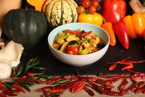 A delicious blend of Thai and Indian cuisines mixed with authentic Thai and Indian spices. Served with peppers, mixed vegetables, coconut milk and garnished with Thai Basil. at Kats Oriental Cuisine in St Albans