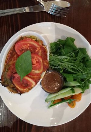 Heirloom tomato, pesto, and cashew cheese lasagna with arugula salad. at be love in Victoria