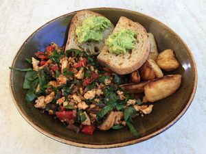 Tofu scramble (which comes with avocado on toast and some hot chips) at Invita Living Food in Melbourne