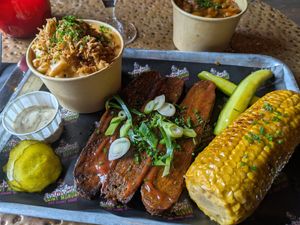 Smoked brisket in bourbon BBQ sauce , smoked corn, and mac and cheese at Saint Monday in East London