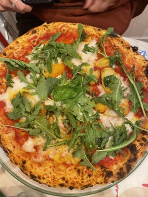 Pizza with tomato, vegan cheese, roasted potatoes, cherry tomatoes and rocket  at Pizzium in Verona