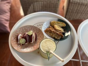 Fresh guava fruit (from their garden), banana and sweet potato fritters (given to me for free). Plus a pineapple juice.   at Los Gili in 