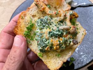 hilli mushroom turmeric cream served with truffle toast,
featuring a delicate balance of flavours. Accompanied by garlic dust, local spinach,
Sarawak white pepper, and dried chil at Manja in Kuala Lumpur