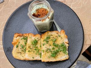 hilli mushroom turmeric cream served with truffle toast,
featuring a delicate balance of flavours. Accompanied by garlic dust, local spinach,
Sarawak white pepper, and dried chil at Manja in Kuala Lumpur