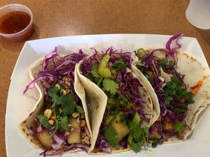 Thai Peanut, Indian Yellow Curry and Panko Crusted “Cod” tacos. Sweet chili & smoked ghost pepper sauce on the side. Excellent!! at Tako Cheena by Pom Pom in Orlando