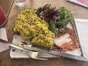 Avo toast with tofu scramble (partially eaten)  at Meo Cafe in Brighton