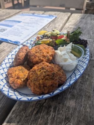 Spicy corn fritters: Sweetcorn, chilli & cayenne pepper fritters. served with a salad garnish & vegan mayo at The Clipper Cafe in Teignmouth