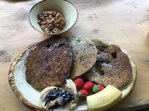 Very tasty, rich flavored pancakes with blueberries and walnuts topped with maple syrup and  assorted with  organic strawberries and banana. And some natto ( fermented soybeans ) as side dish.
 at Earth Hostel - Nikko Riverhouse in Nikko