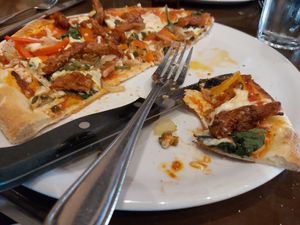 Socca pizza with vegan cajun chickun, peppers, spinach and vegan mozeralla at Del Friscos in Dollard-des-ormeaux