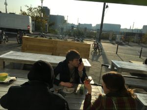 Sit outside of Veganz, close to subway station 'Warschauer Str.' at Goodies Berlin - Friedrichshain in Berlin