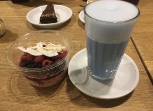 Hot almond spirulina latte and gluten-free overnight oats soaked in coconut milk, ginger, mixed seeds  at Goodies Berlin - Globetrotter - Maybe closed in Berlin