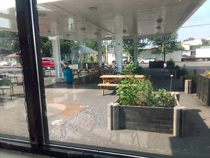 Looking through the window to the outside seating at The Station Market & Cafe in Frederick