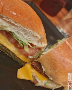 Homemade burger with falafel steak and possible toppings halloumi, eggplant, zucchini, tofu, potato patty, vegan mozza. at Veganil in Paris