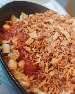Kochari, Mixture of rice, pasta, brown lentils, chickpeas, tomato sauce and fried onions at Veganil in Paris