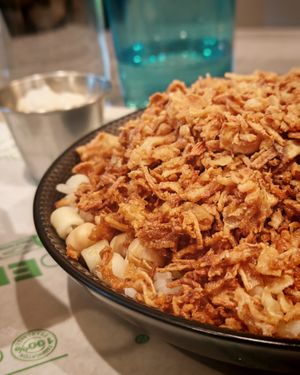 Kochari

A mixture of rice, pasta, brown lentils, chickpeas, tomato sauce, and fried onions. at Veganil in Paris