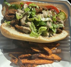 Po’ Boy Sandwich with Cajun Sweet Potato Fries  at The Red Fern in Rochester