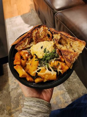 Take-out Rigatoni Pasta Bake: Rigatoni baked with Marinara, Mozzarella, Tofu Ricotta, Italian Sausage, Kale, Fresh Basil & Garlic Toasts at The Red Fern in Rochester