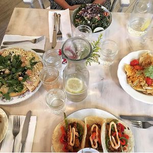 clockwise from top: Thai Peanut Kale Salad, Mac & Cheese Nachos, Taco Tuesday Special, Flatbread Special at The Red Fern in Rochester