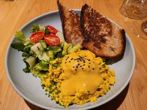 Scrambled tofu with salad, cale, bread, and hollandaise sauce at Kafé Oransjeriet in Stavanger