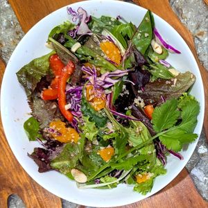 Crunchy Mandarin Salad - Mixed greens, white quinoa, red bell pepper, purple cabbage, mandarin oranges, green onion, almond slices, orange vinaigrette, cilantro sprig at Key West Salad Shack - Pre Order Only in Key West